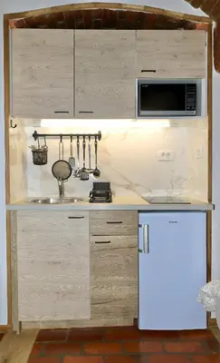 a kitchen with a white refrigerator and a microwave at Podroom Apartments in Ljubljana
