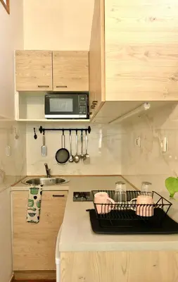 a kitchen with a counter top with a stove top oven at Podroom Apartments in Ljubljana