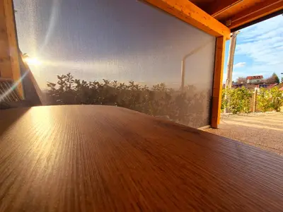 a room with a wooden floor and a large window at Apartment Teja in Brezovec