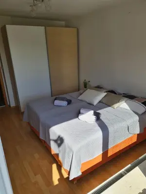 a bedroom with a large bed with two towels on it at Apartment Carolina in Rogašovci