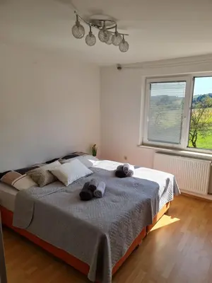 a bedroom with a bed with two stuffed animals on it at Apartment Carolina in Rogašovci