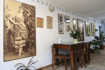 a room with a table and a painting of a woman on a wall at New boutique apartments house Gabrijela Mrak in old Tolmin in Tolmin