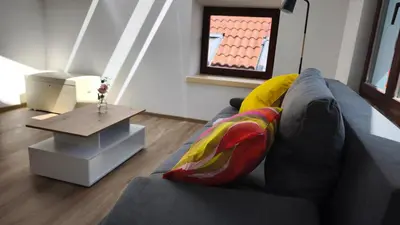 a living room with a couch and a table at New boutique apartments house Gabrijela Mrak in old Tolmin in Tolmin