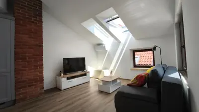 a living room with a couch and a tv at New boutique apartments house Gabrijela Mrak in old Tolmin in Tolmin