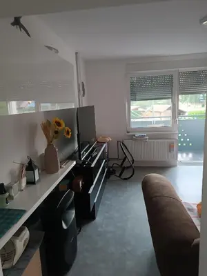 a living room with a couch and a desk at Apartma Dobrodošli pri Renati v Celju in Celje