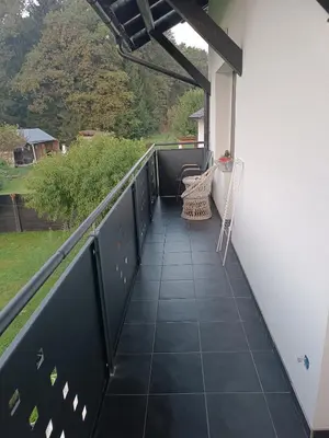 a balcony with a black railing and a table and chairs at Apartma Dobrodošli pri Renati v Celju in Celje