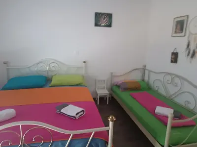 a bedroom with two beds with colorful sheets at Apartma Dobrodošli pri Renati v Celju in Celje