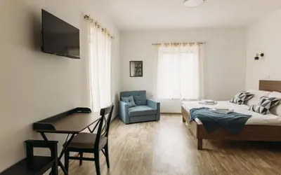 a bedroom with a bed and a desk and a chair at Hiša na Ravnah in Pišece
