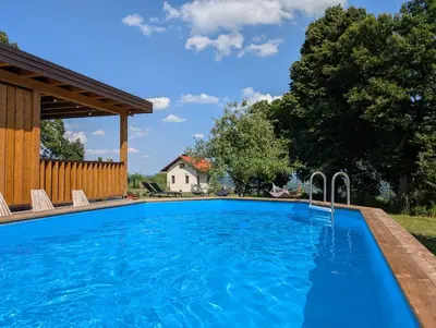 a swimming pool with blue water in a yard at Hiša na Ravnah in Pišece