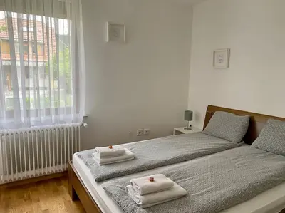 a bedroom with a bed with towels on it at Spacious APT in a Quiet Neighbourhood + Private Parking in Ljubljana