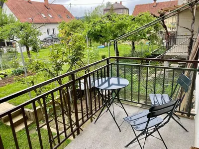 two chairs and a table on a balcony at Spacious APT in a Quiet Neighbourhood + Private Parking in Ljubljana