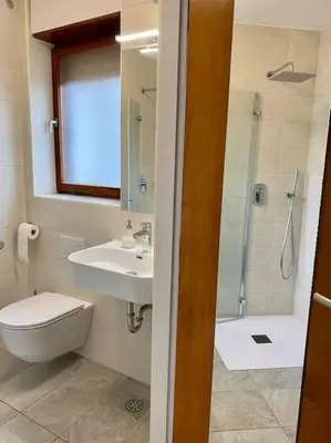 a bathroom with a sink and a toilet and a shower at Spacious APT in a Quiet Neighbourhood + Private Parking in Ljubljana