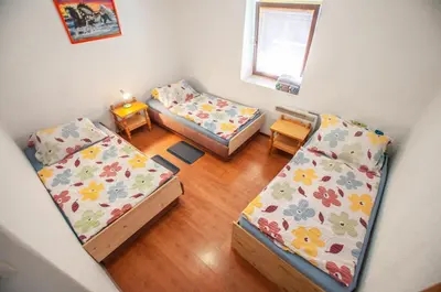 an overhead view of a room with three beds at Hostel, Rooms and Apartment Ceklin in Bohinj