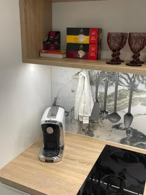a kitchen counter with a toaster on a shelf at Studio with a view on City center park in Maribor