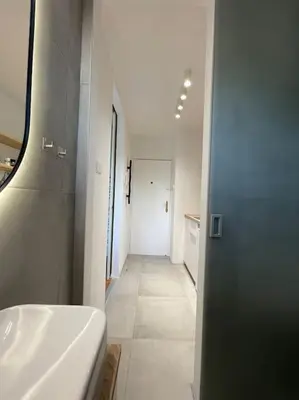 a white bathroom with a sink and a tub at Studio with a view on City center park in Maribor