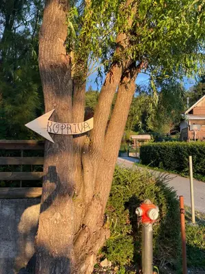 a sign on a tree that says reptilia at Koča Kopriva in Križe