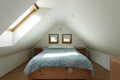 a bedroom with a bed in the attic at Koča Kopriva in Križe