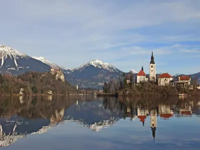 a castle on an island in the middle of a lake at Apartments Skok in Bled