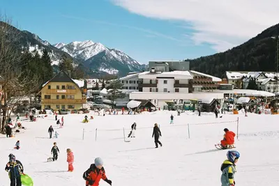 a group of people skiing on a ski slope at Apartments Rožič in Kranjska Gora
