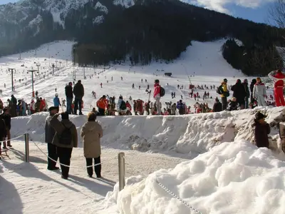 a group of people on a snow covered ski slope at Apartments Rožič in Kranjska Gora
