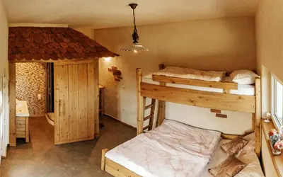 a room with two bunk beds and a closet at Gostilnica Orle - Sleeping in the tower in Škofljica