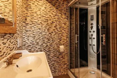 a bathroom with a sink and a shower at Gostilnica Orle - Sleeping in the tower in Škofljica