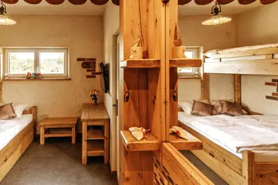 a room with two bunk beds and a table at Gostilnica Orle - Sleeping in the tower in Škofljica