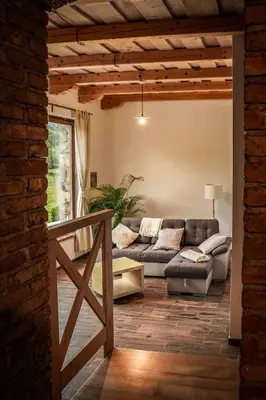 a living room with a couch and a table at Holiday Home GaMaJaMa in Dobravlje