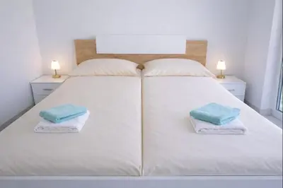 a large white bed with two pillows on it at Jacobs Legacy - 4 Bedroom House, Free Parking, near City Center in Ljubljana