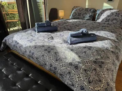 a bed with two blue towels on top of it at Apartment Bacci in Vrhnika