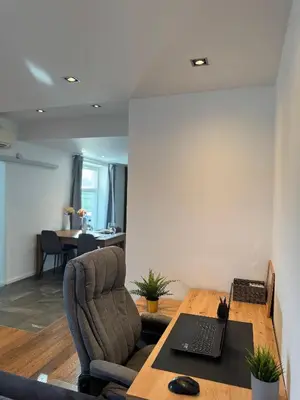 an office with a desk with a laptop and a chair at Apartment Bacci in Vrhnika
