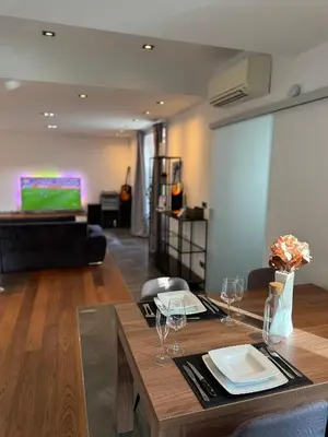 a living room with a table with wine glasses at Apartment Bacci in Vrhnika