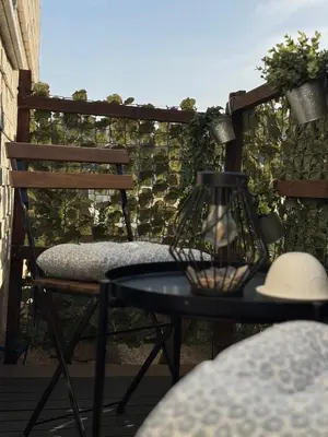 a patio with a table and a chair on a balcony at Apartment Bacci in Vrhnika