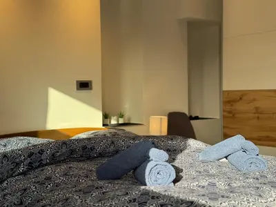 a bedroom with a bed with blue towels on it at Apartment Bacci in Vrhnika