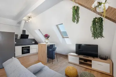a living room with a couch and a tv at SMART APARTMENT LJUBLJANA in Spodnja Šiška