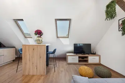 a living room with a tv and a table and chairs at SMART APARTMENT LJUBLJANA in Spodnja Šiška