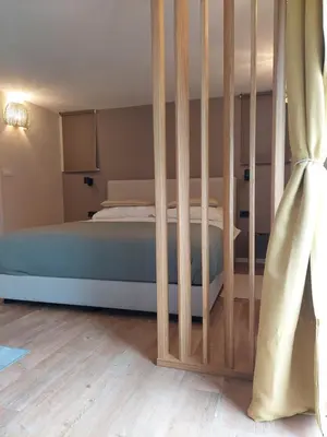 a bedroom with a bed with a wooden crib at Ljubljana's secret place in Ljubljana