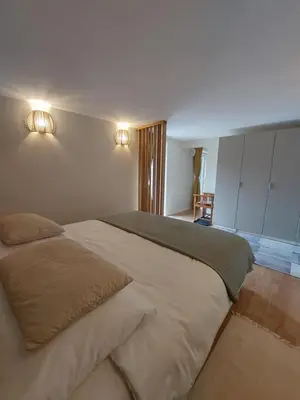 a bedroom with a large bed and lights on the wall at Ljubljana's secret place in Ljubljana