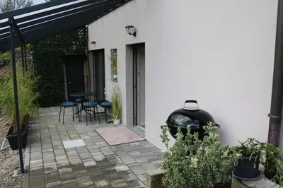 a patio with a grill next to a house at Ljubljana's secret place in Ljubljana