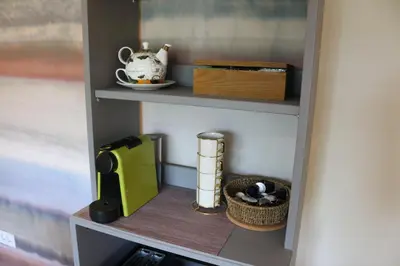 a book shelf with a tea pot and a kettle at Ljubljana's secret place in Ljubljana