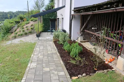 a walkway outside of a house with a garden at Ljubljana's secret place in Ljubljana