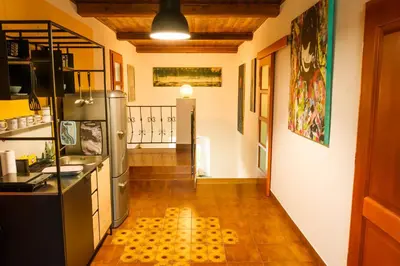 a kitchen with a refrigerator and a tile floor at LAAS ART GALLERY in Stari Trg pri Ložu