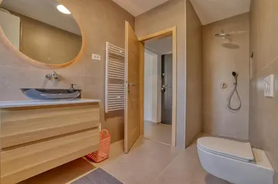 a bathroom with a sink and a toilet and a mirror at Dragon Residence in Ljubljana