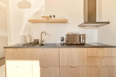 a kitchen with a sink and a microwave at Dragon Residence in Ljubljana