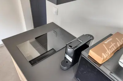 a counter with a cell phone and a remote control at Dragon Residence in Ljubljana