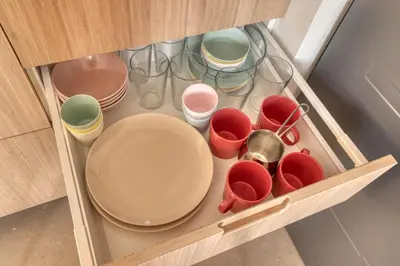 a cupboard with plates and cups and bowls at Dragon Residence in Ljubljana