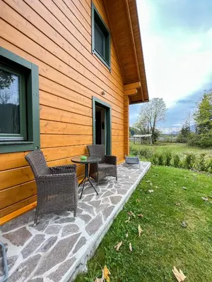 a patio with chairs and a table next to a house at Apartment Jeršin in Rateče