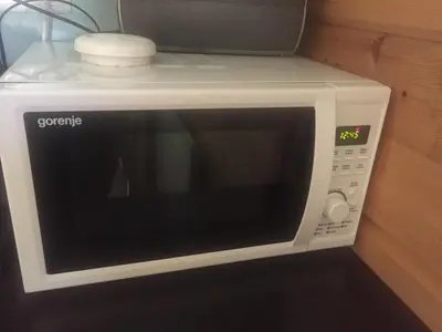 a white microwave oven sitting on top of a counter at Apartment Jeršin in Rateče