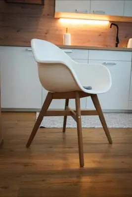 a white chair sitting in front of a kitchen counter at Apartment Jeršin in Rateče