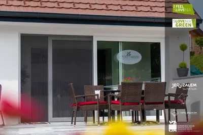 a table and chairs in front of a restaurant at POD OREHI - Hiša na podeželju - RAZPRŠENI HOTEL Jeruzalem Slovenija in Miklavž pri Ormožu